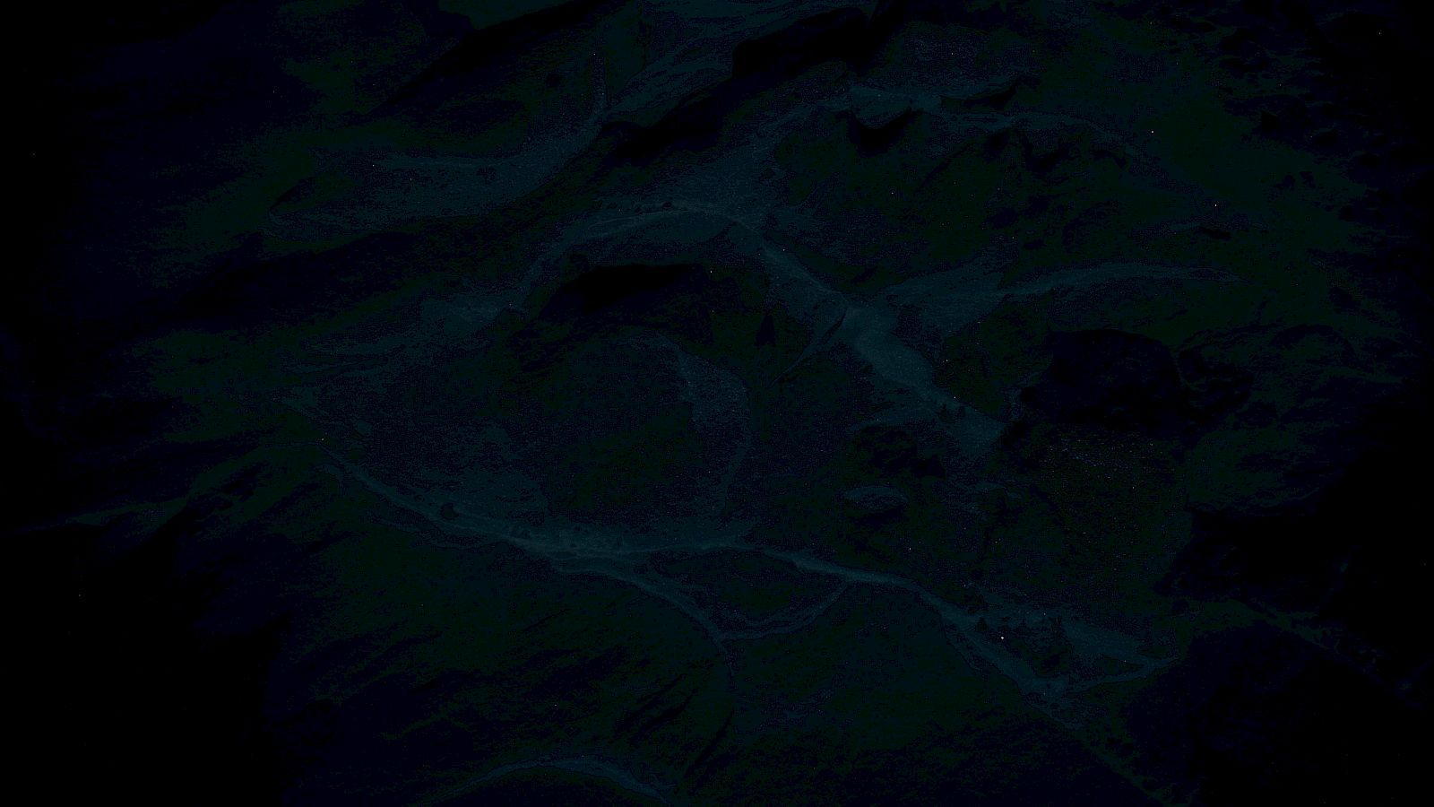 The image is very dark and unclear, possibly abstract, with shades of blue and black swirling throughout.